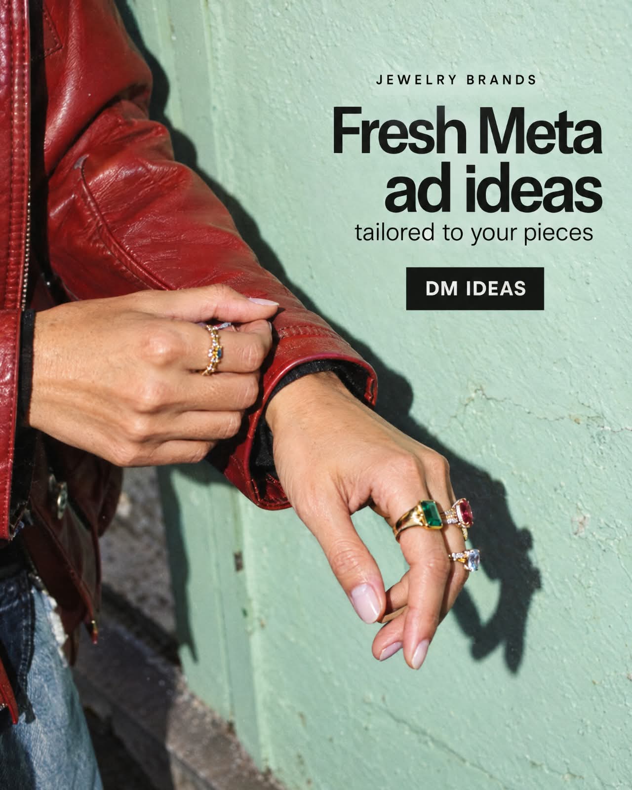 Colourful gemstone rings styled with a red leather jacket against a mint wall, Fresh Meta ad ideas headline and DM IDEAS call to action